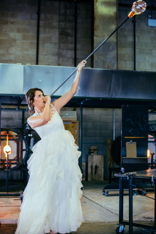 Vika, wearing a Valentino gown from Belle Vie, blowing glass through a pipe.  Amanda at Belle Vie did not know about this molten glass business when she loaned me the dress.