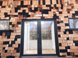 Artist residency at Woodlab, Dartington - Shingled wall highlighting the hardwoods and softwoods that grow locally to the project.